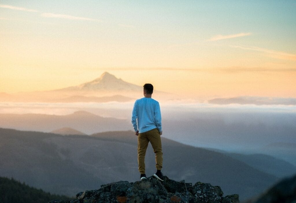 VETS2INDUSTRY | Man standing on top of a mountain trying to decide where his career is going to go
