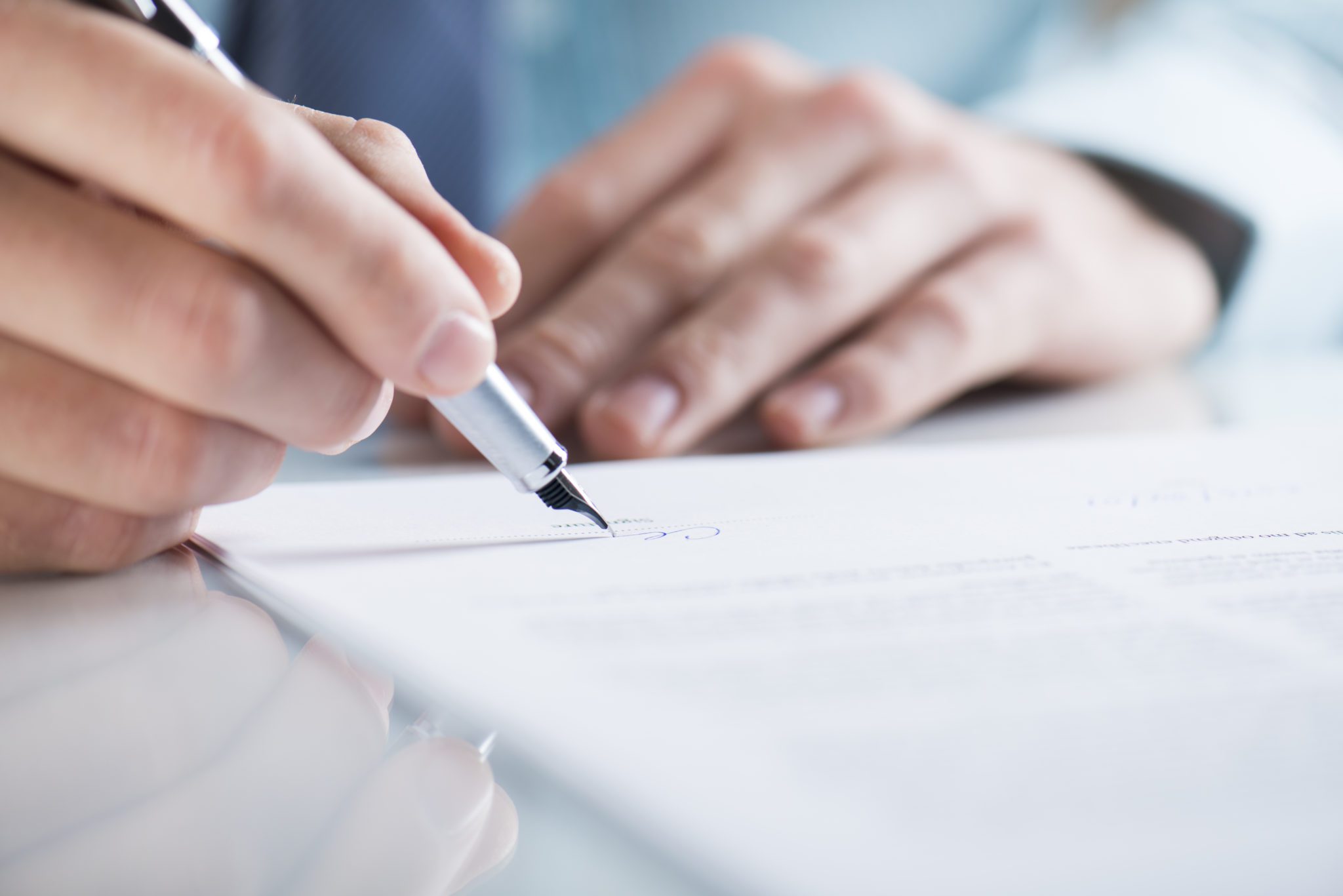 A person signing their offer letting and total compensation package